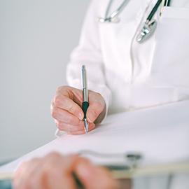 Image of doctor writing on a clipboard
